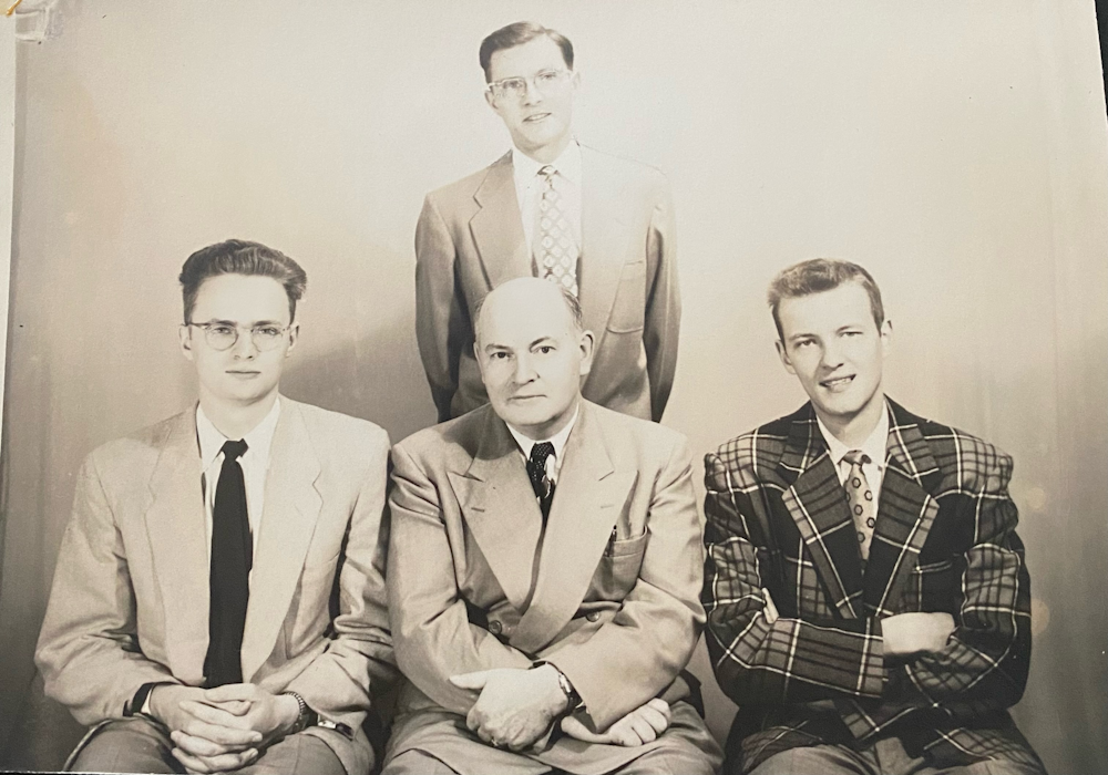 Harry (left, seated) with father George, and brothers George (standing) and Jack (right, seated)