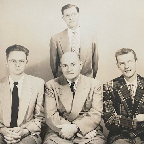 Harry (left, seated) with father George, and brothers George (standing) and Jack (right, seated)