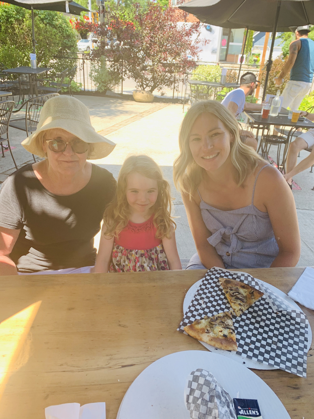 The ladies in the sunshine with pizza in Prince Edward County. 